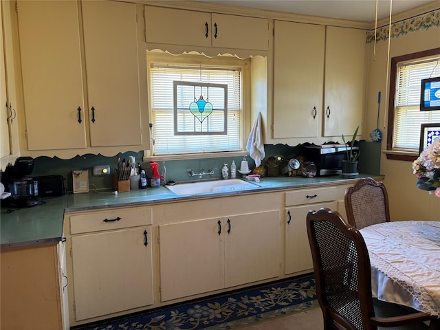 504 E Bell Ave, Crockett, TX 75835 - kitchen with a sink, light countertops, and stainless steel microwave