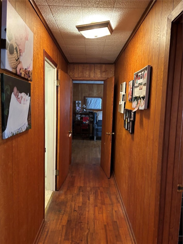 504 E Bell Ave, Crockett, TX 75835 - corridor featuring hardwood / wood-style flooring and wooden walls