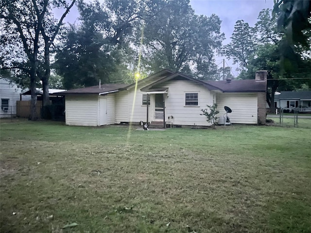 504 E Bell Ave, Crockett, TX 75835 - rear view of property featuring entry steps and a chimney