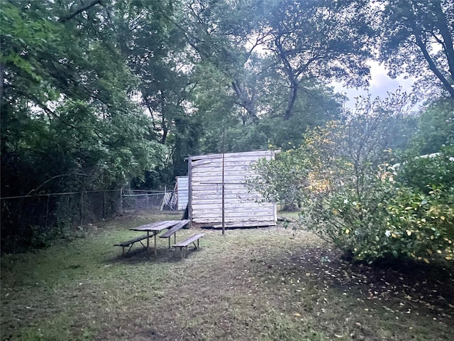 504 E Bell Ave, Crockett, TX 75835 - view of yard with a storage shed, fence, and an outbuilding