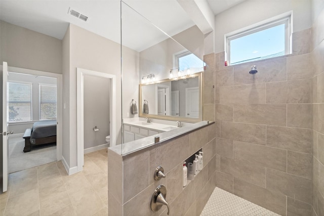 full bathroom with baseboards, visible vents, walk in shower, tile patterned floors, and toilet