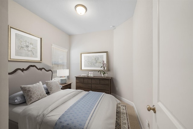 bedroom with baseboards and carpet