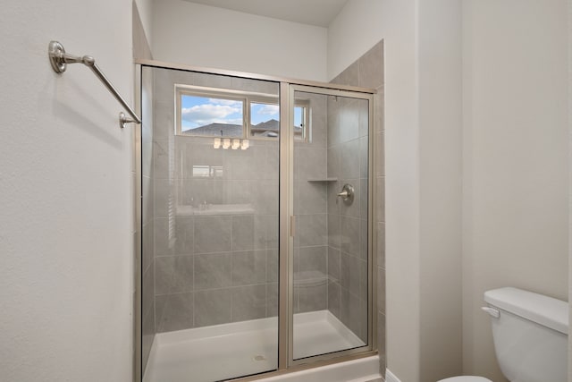 bathroom with an enclosed shower and toilet