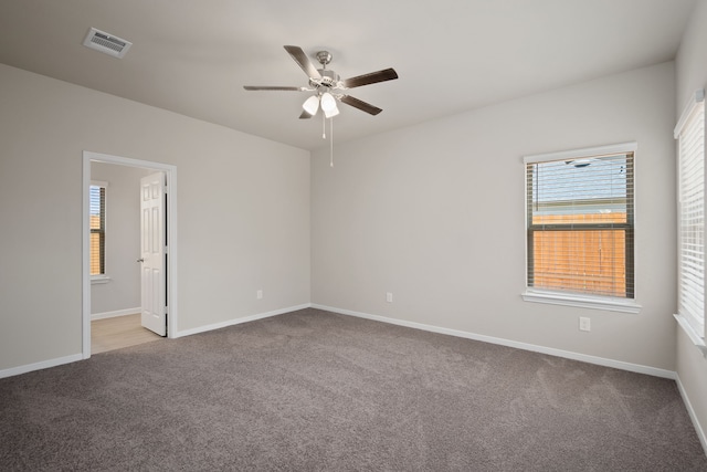 empty room featuring light carpet and ceiling fan