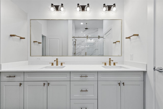 bathroom featuring a shower with door and vanity