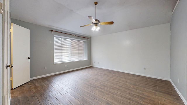 spare room featuring dark wood-type flooring, baseboards, and a ceiling fan