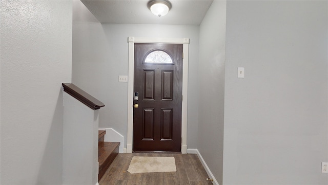 entryway featuring dark wood-style flooring and baseboards