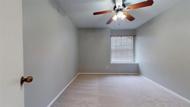 empty room featuring baseboards, a ceiling fan, and light colored carpet