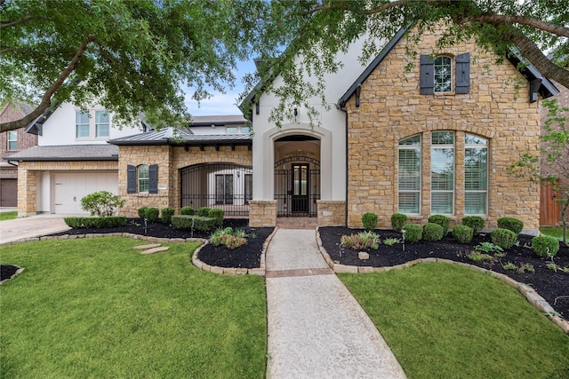 view of front of home with a garage and a front lawn