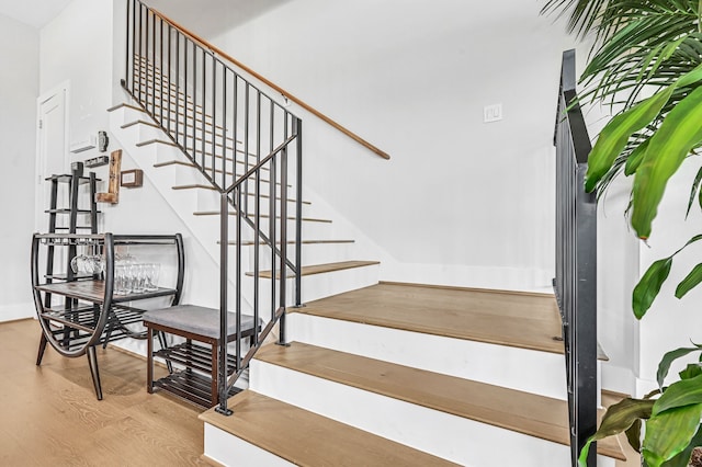 stairs featuring wood-type flooring