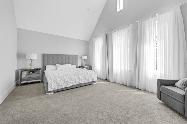 carpeted bedroom featuring high vaulted ceiling