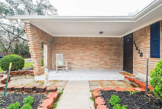 property entrance featuring brick siding