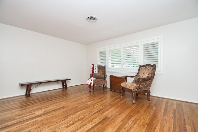 sitting room with hardwood / wood-style floors