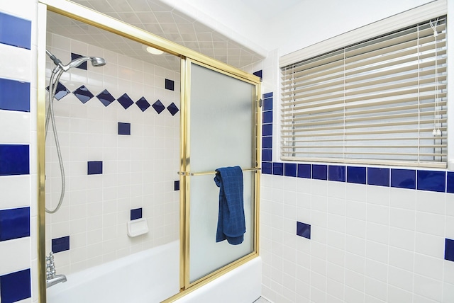 bathroom with shower / bath combination with glass door