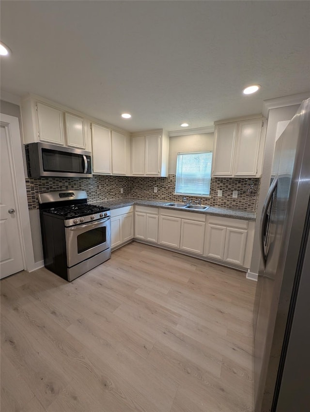 kitchen featuring white cabinetry, stainless steel appliances, and light hardwood / wood-style floors