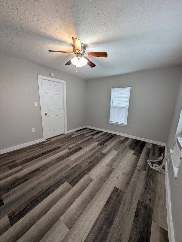 spare room featuring ceiling fan, a textured ceiling, and dark hardwood / wood-style flooring