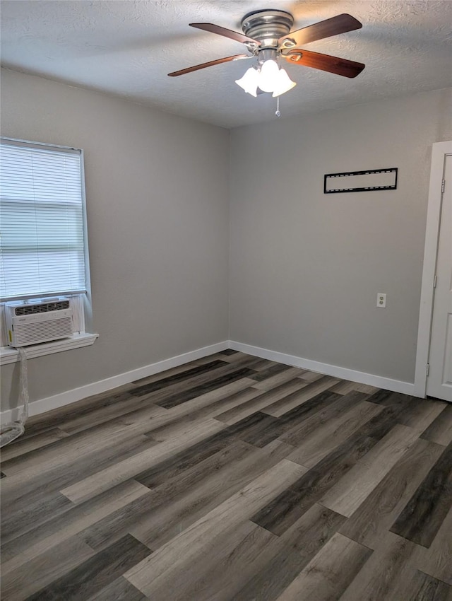 empty room featuring ceiling fan, dark hardwood / wood-style flooring, and a textured ceiling