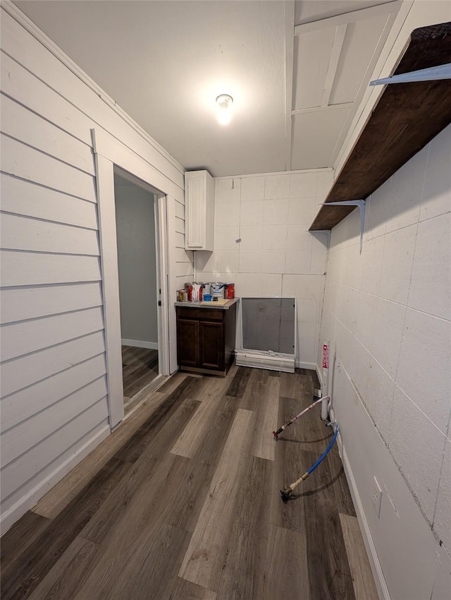 laundry area featuring dark wood-type flooring