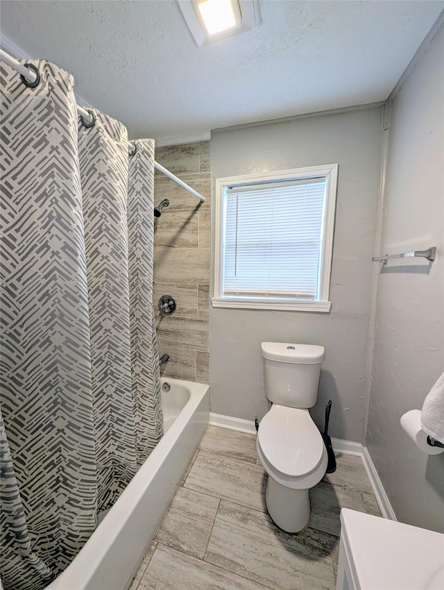 full bathroom featuring vanity, shower / tub combo, a textured ceiling, and toilet