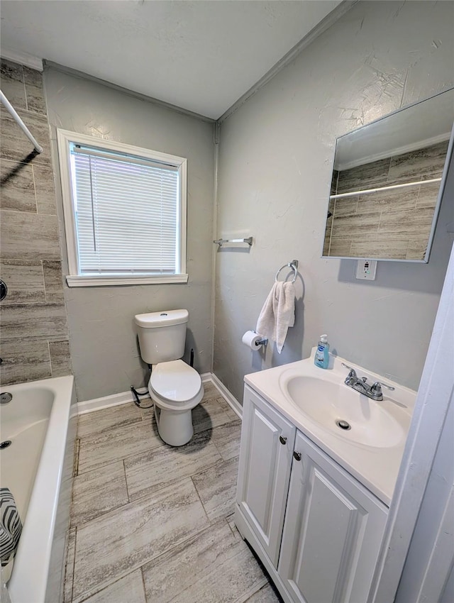 full bathroom with vanity, tiled shower / bath, and toilet