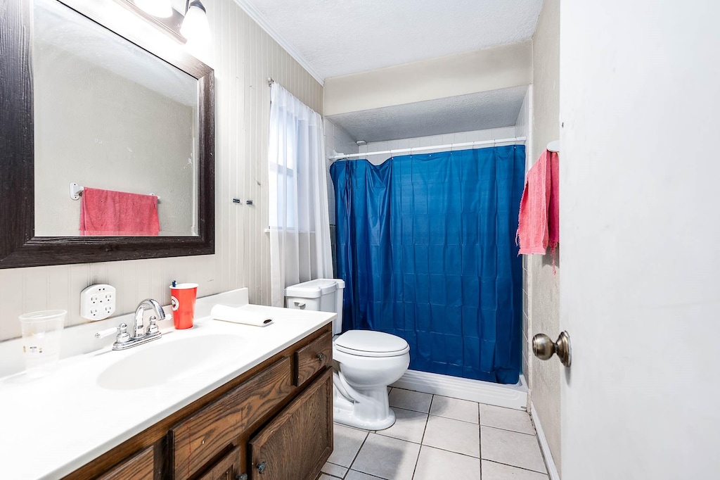 bathroom featuring tile patterned flooring, vanity, and toilet