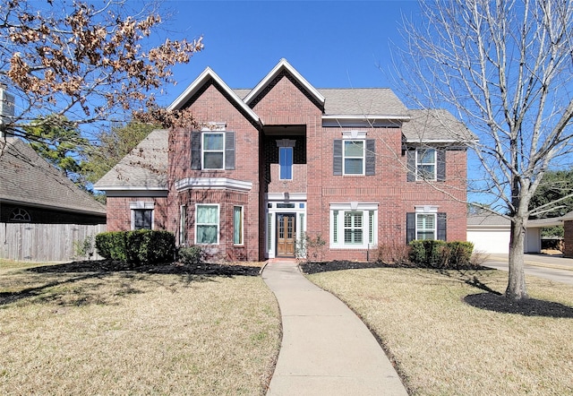 view of front of home with a garage and a front lawn