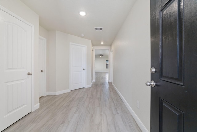 hallway with light hardwood / wood-style floors