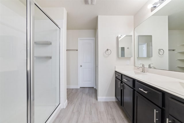 bathroom with vanity, hardwood / wood-style floors, and walk in shower