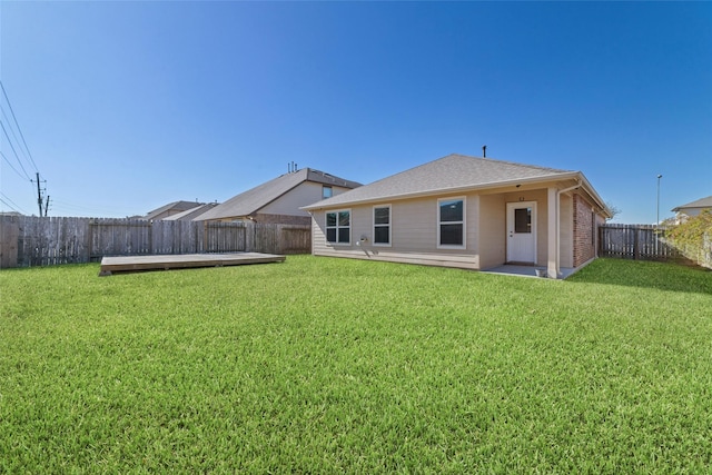 rear view of house featuring a yard