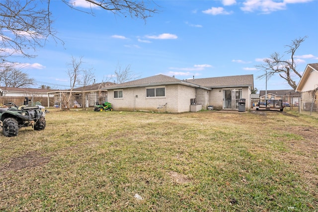 rear view of house featuring a yard