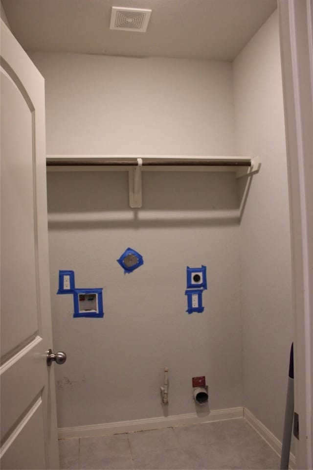 laundry area with hookup for a gas dryer, light tile patterned flooring, and hookup for a washing machine