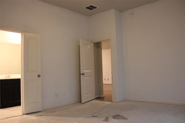 unfurnished bedroom featuring ensuite bath and sink