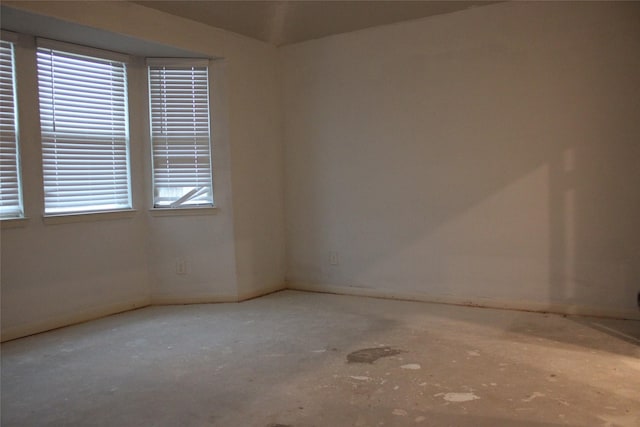 unfurnished room with concrete floors