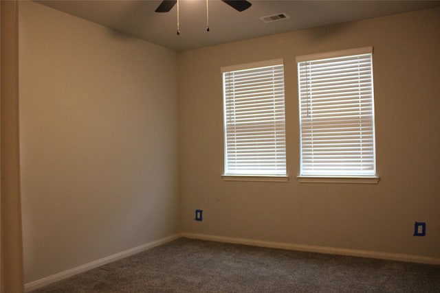 carpeted spare room featuring plenty of natural light and ceiling fan