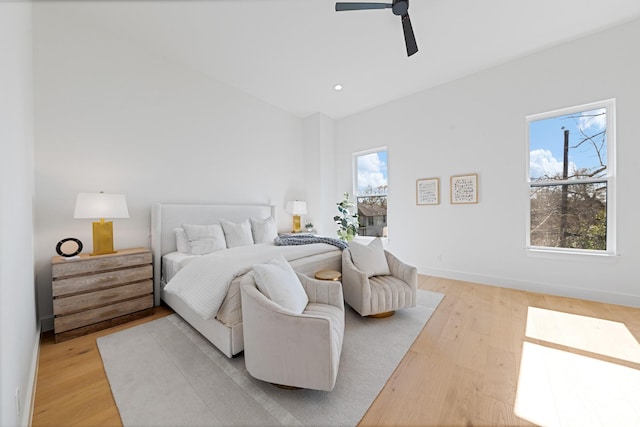 bedroom featuring multiple windows, light wood-type flooring, and ceiling fan