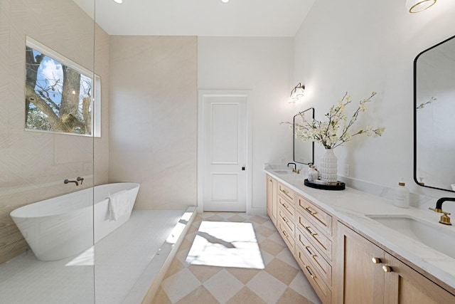 bathroom with vanity and a bath