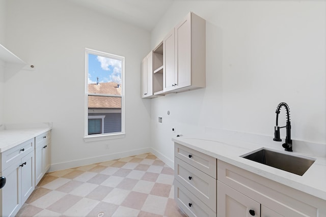 clothes washing area with cabinets, washer hookup, sink, and electric dryer hookup