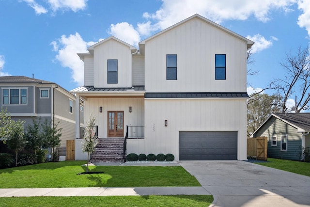 view of front of property featuring a garage and a front yard