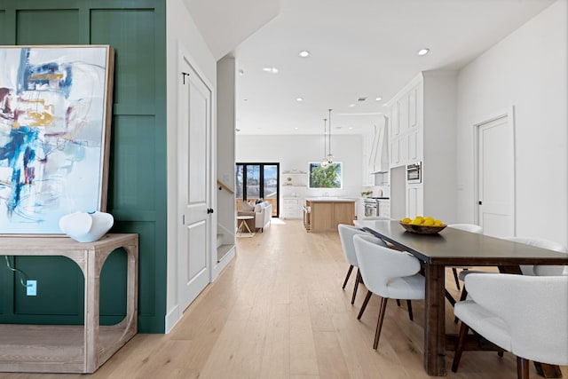 dining space featuring light wood-type flooring