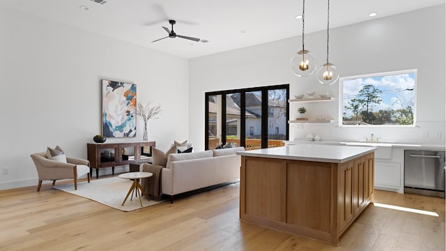 kitchen with white cabinetry, pendant lighting, dishwasher, and light wood-type flooring