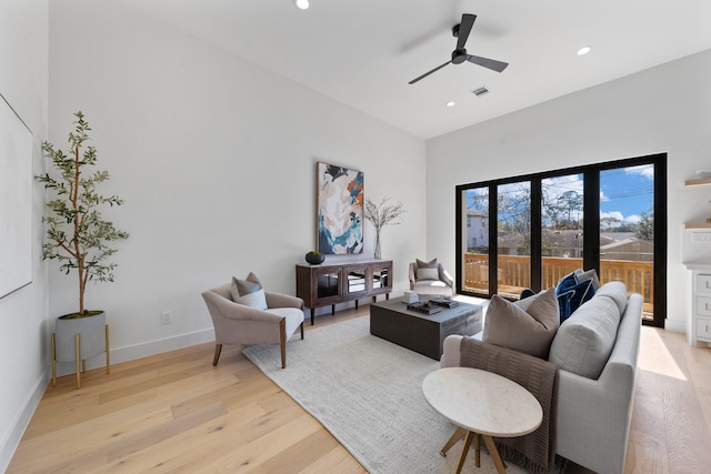 living room with ceiling fan and light wood-type flooring