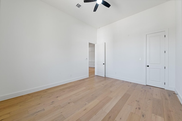 spare room with vaulted ceiling, light hardwood / wood-style floors, and ceiling fan