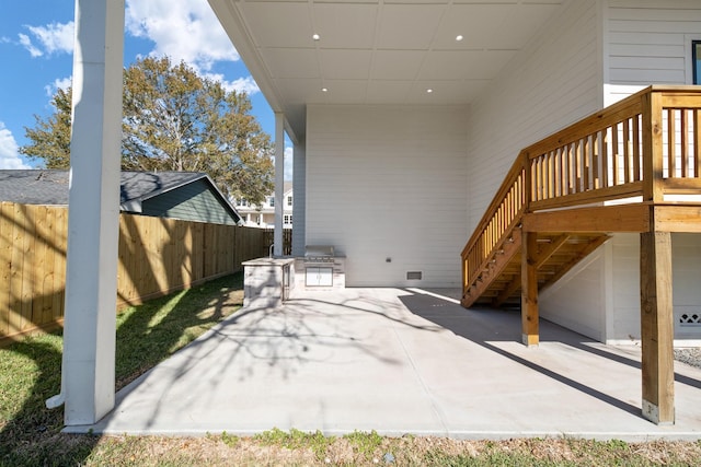 view of patio / terrace with stairs and fence