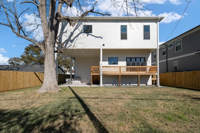 rear view of property featuring a lawn, a patio area, and a fenced backyard