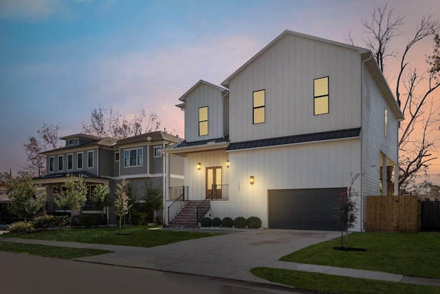 view of front of house featuring driveway, a standing seam roof, a garage, and board and batten siding