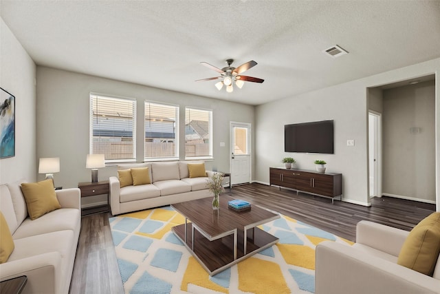 living room featuring hardwood / wood-style flooring, ceiling fan, a textured ceiling, and a wealth of natural light