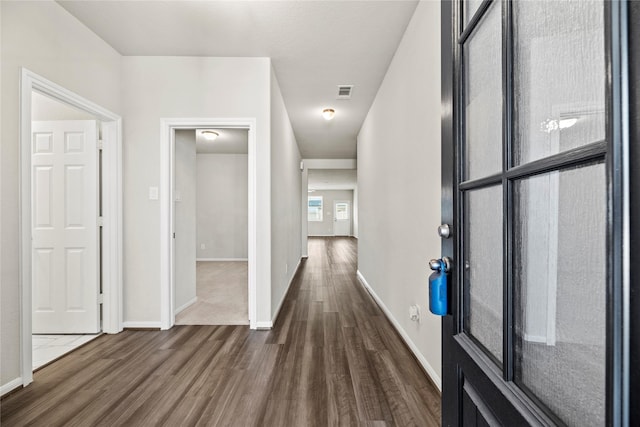 hallway featuring dark wood-type flooring