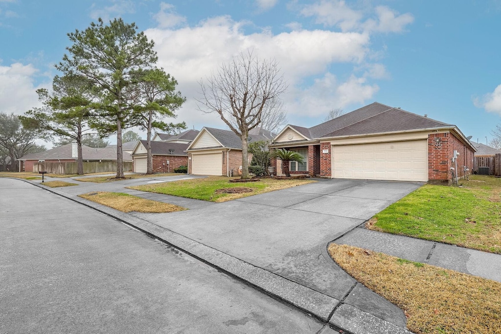 ranch-style home featuring a garage and a front yard