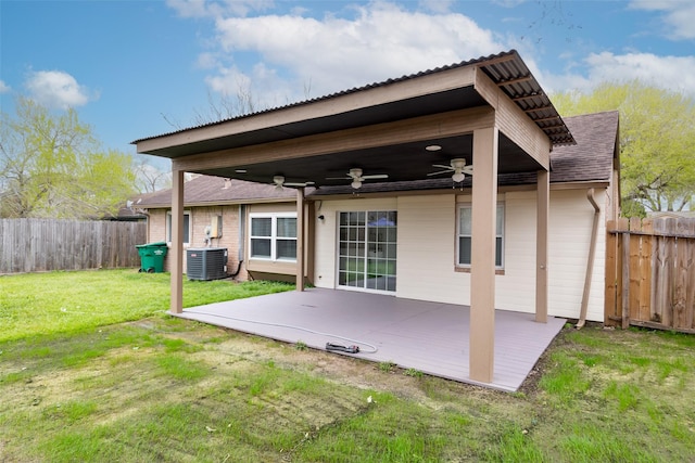 back of house featuring central air condition unit, a lawn, fence, ceiling fan, and a patio area