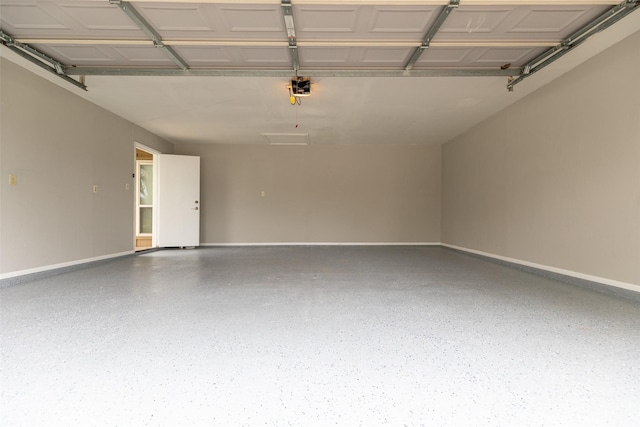 garage with a garage door opener and baseboards